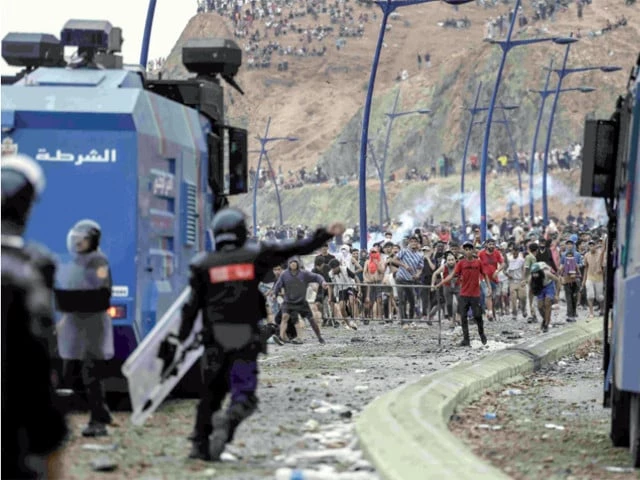 migrant crises moroccan security forces confront migrants attempting to cross into spain s north african enclave of ceuta during clashes near the town of fnideq on the morocco spain border photo afp migrant crises moroccan security forces confront migrants attempting to cross into spain s north african enclave of ceuta during clashes near the town of fnideq on the morocco spain border photo afp