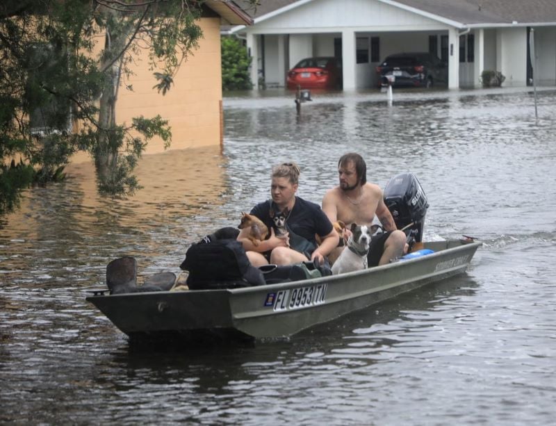 residents and their pets evacuate magnolia avenue after hurricane milton flooded the neighborhood in south daytona florida october 10 photo reuters