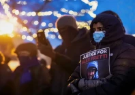 people mourn at a makeshift memorial in the area where 37 year old alex pretti was shot dead by federal immigration agents earlier in the day in minneapolis minnesota on january 24 2026 photo afp