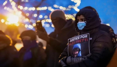 people mourn at a makeshift memorial in the area where 37 year old alex pretti was shot dead by federal immigration agents earlier in the day in minneapolis minnesota on january 24 2026 photo afp