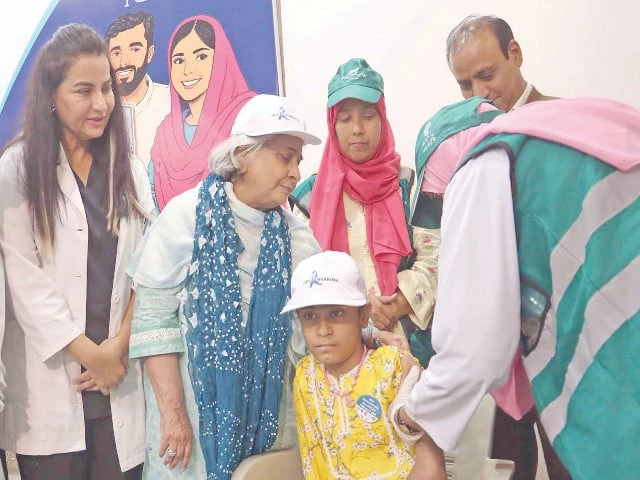 health minister dr azra pechuho stands beside a young girl receiving the hpv vaccine at the karachi press club photo jalal qureshi express health minister dr azra pechuho stands beside a young girl receiving the hpv vaccine at the karachi press club photo jalal qureshi express