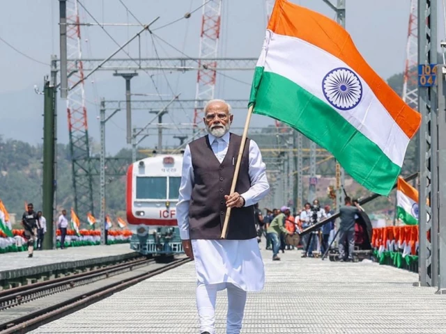 this photograph taken and released by the indian press information bureau pib on 6 june 2025 shows india s prime minister narendra modi holding national flag during the inauguration of the chenab rail bridge in reasi indian illegally occupied jammu and kashmir photo afp