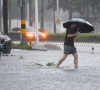 a man braves the rain as he makes his way through a flooded section of the road amid heavy rainfall brought by typhoon matmo in haikou hainan province china october 5 2025 photo reuters