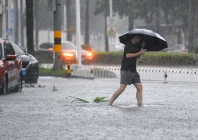 a man braves the rain as he makes his way through a flooded section of the road amid heavy rainfall brought by typhoon matmo in haikou hainan province china october 5 2025 photo reuters