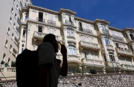 people walk past a residential building the site of an explosion that occurred on monday in monaco reuters