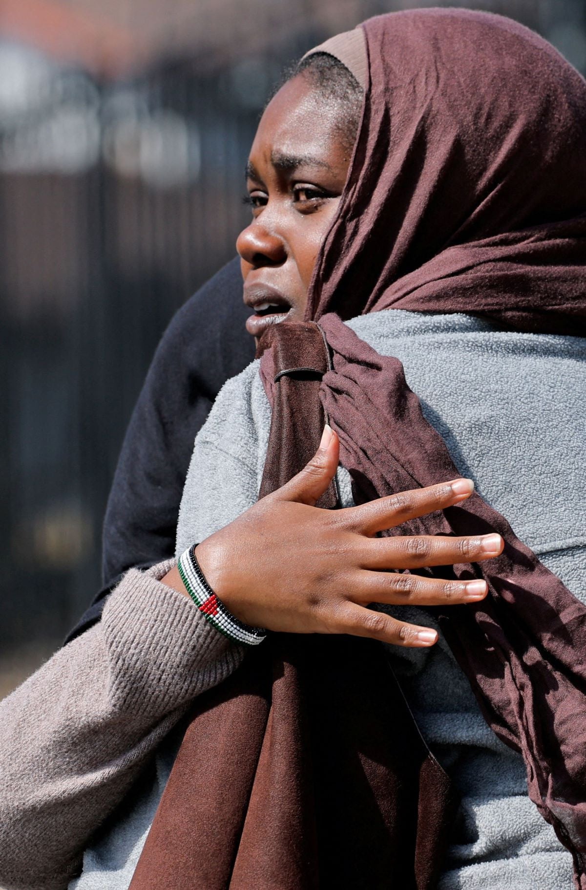 Women hug as they wait for the children to walk out of the mosque, at a collecting area, at the scene of a shooting at the Islamic Center in San Diego, California, US, May 18, 2026.  REUTERS