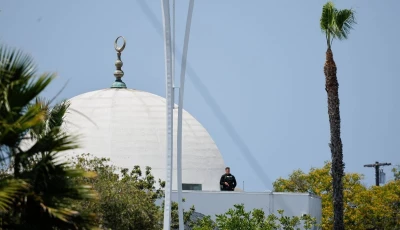a police officer stands guard as emergency workers respond at the scene of a reported active shooter situation at the islamic center in san diego california us may 18 2026 reuters