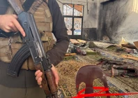 an armed man stands inside the imam ali ibn abi talib mosque following an explosion in the wadi al dahab neighborhood of homs on december 26 2025 photo afp