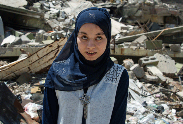 Nour al Ta'i (C), a 15-year-old blind resident of East Mosul and participant in 