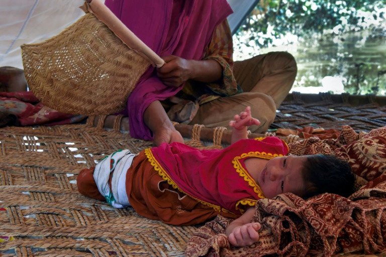 hajira bibi and her newborn daughter inside a tent near her flooded home in jindi village in khyber pakhtunkhwa photo afp