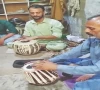 israr hussain checks a tabla in his workshop in dijkot photo app