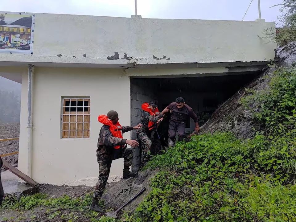 Rescuers assist a man, amid flash floods, in a location given as Dharali, Uttarakhand, India, in this handout image released on August 5, 2025. PHOTO:REUTERS