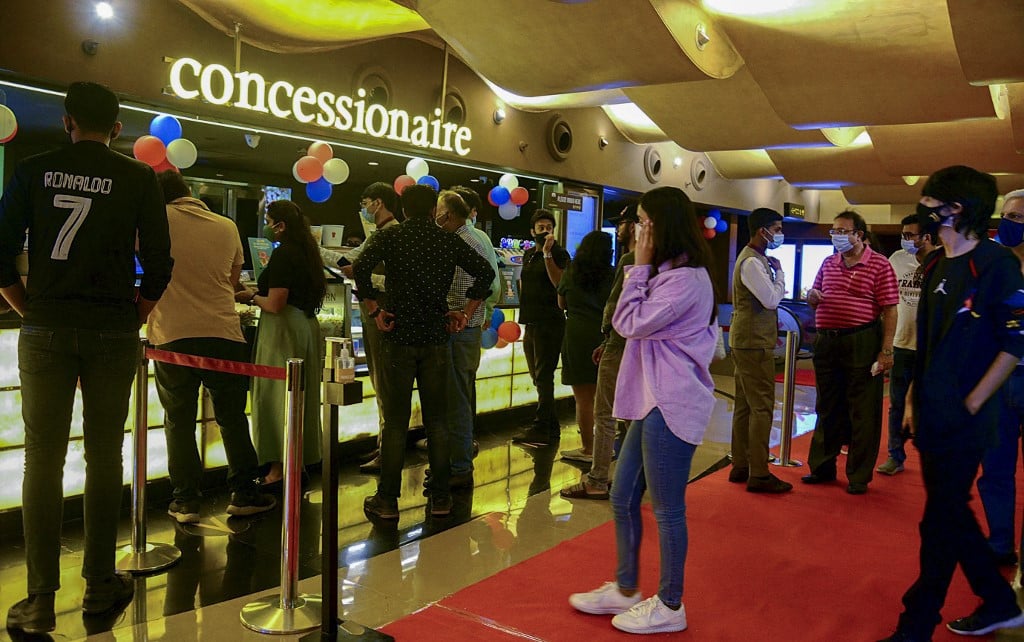 cinema goers queue up to buy snacks during intermission time at a cinema theatre in mumbai on october 22 2021 as cinemas reopened weeks after the covid 19 coronavirus lockdown photo afp