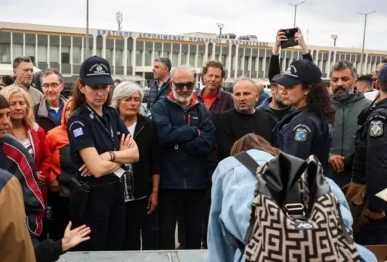 police officers watch members of the global sumud flotilla vessels intercepted by the israeli navy in international waters demonstrating in the town of ierapetra in the island of crete greece on may 1 2026 photo afp
