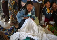mourners grieve as bodies are laid out at a cemetery before their burial following a myanmar military air strike at a hospital that killed more than 30 people in mrauk u in western rakhine state on december 11 2025 photo afp