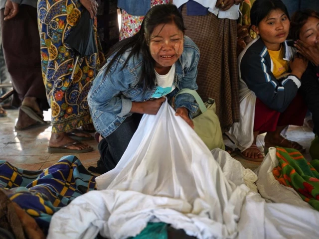 mourners grieve as bodies are laid out at a cemetery before their burial following a myanmar military air strike at a hospital that killed more than 30 people in mrauk u in western rakhine state on december 11 2025 photo afp mourners grieve as bodies are laid out at a cemetery before their burial following a myanmar military air strike at a hospital that killed more than 30 people in mrauk u in western rakhine state on december 11 2025 photo afp