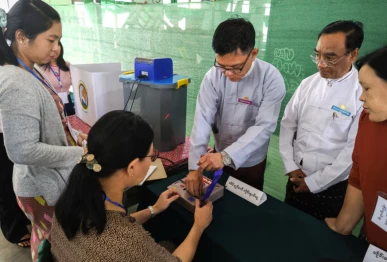 election commission officials prepare at a polling station inside a school ahead of a general election in thingangyun township yangon myanmar december 27 2025 photo reuters