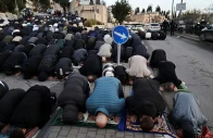 palestinian muslim worshippers pray by a road to mark the end of ramazan as they are not permitted to attend the eidul fitr prayers at al aqsa compound in jerusalem on march 20 2026 photo reuters