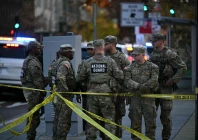 national guard soldiers gather near a crime scene after a shooting in downtown washington dc on november 26 2025 two members of the national guard were shot wednesday just blocks from the white house according to officials as a spokesperson for donald trump said the president has been briefed on the tragic situation police said they had detained a suspect photo afp