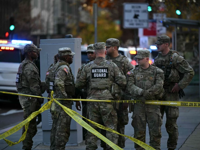 national guard soldiers gather near a crime scene after a shooting in downtown washington dc on november 26 2025 two members of the national guard were shot wednesday just blocks from the white house according to officials as a spokesperson for donald trump said the president has been briefed on the tragic situation police said they had detained a suspect photo afp