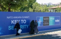 people walk past billboards built for upcoming nato summit in ankara turkey july 1 2026 reuters