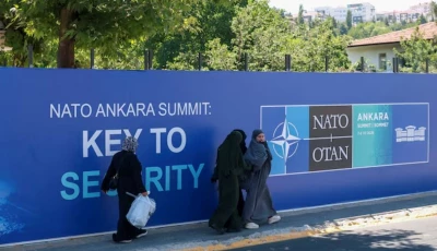 people walk past billboards built for upcoming nato summit in ankara turkey july 1 2026 reuters