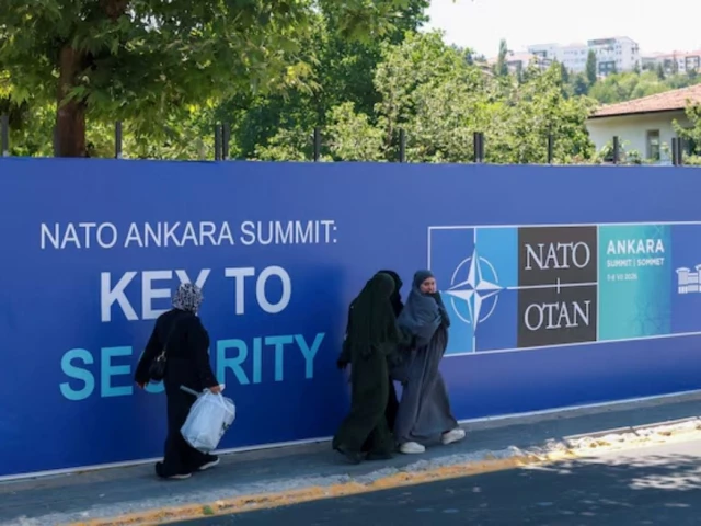 people walk past billboards built for upcoming nato summit in ankara turkey july 1 2026 reuters people walk past billboards built for upcoming nato summit in ankara turkey july 1 2026 reuters