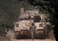 a us soldier walks in front of an armoured vehicle during balkan sentinel   25 military drill an exercise involving personnel and equipment from the bulgarian land forces and air force formations from the nato multinational battle group with italy and a mechanized platoon from the romanian land forces in koren bulgaria june 9 2025 photo reuters