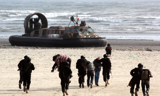 Guests witnessed a mock exercise demonstrating a combat situation between terrorists and navy personnel during which navy personnel recovered hostages from a terrorist group. PHOTO: ATHAR KHAN