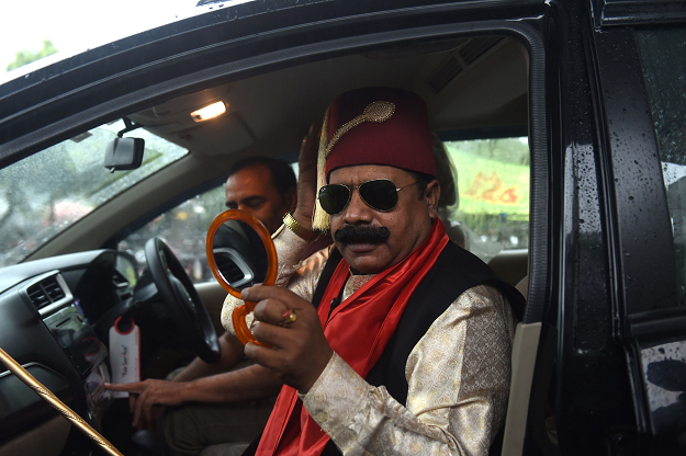 Nawabzada Amber Shahzada, an independent Pakistani candidate contesting a the National Assembly, prepares before embarking on an election campaign in Lahore. PHOTO: AFP.