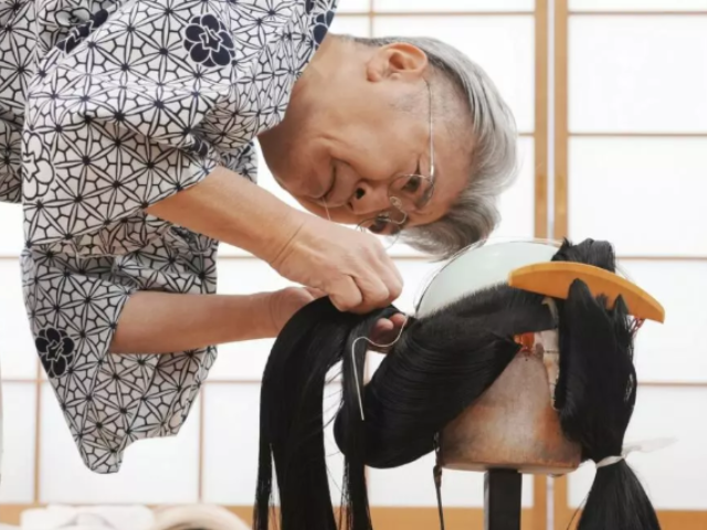 After a craftsman creates the wigs using human hair, wig masters like Tadashi Kamoji style them © Kazuhiro NOGI / AFP