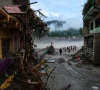 people stand next to damaged buildings following the deadly flash floods and a mudslide in devighat nuwakot district nepal september 4 2026 photo reuters