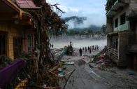 people stand next to damaged buildings following the deadly flash floods and a mudslide in devighat nuwakot district nepal september 4 2026 photo reuters
