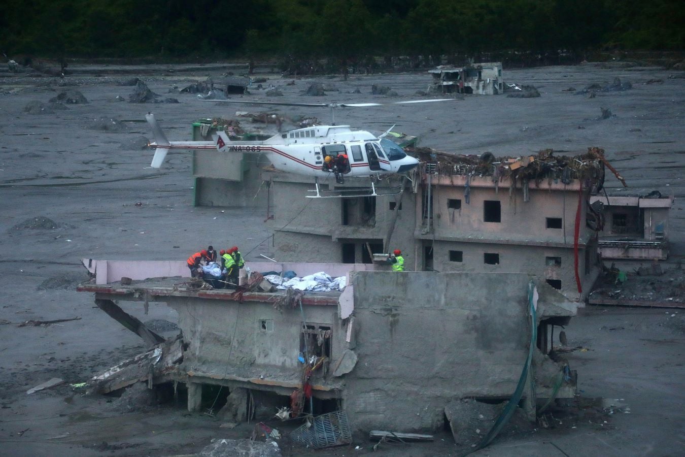 Rescuers prepare to lift the body of a victim of deadly flash floods and mudslides, from the roof of a damaged house in Betrawati Bazaar, Nepal, August 31, 2026. REUTERS