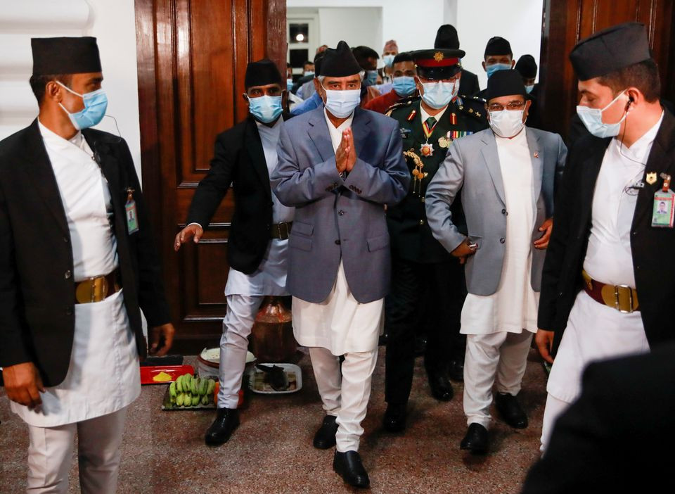 newly appointed prime minister sher bahadur deuba wearing a face mask walks after formally assuming office at singha durbar office complex that houses the prime minister s office and other ministries in kathmandu nepal july 13 2021 photo reuters