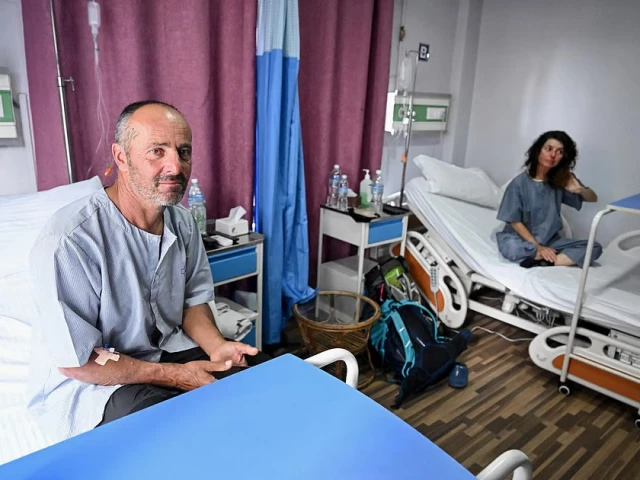 avalanche survivors france s didier armand berton l and isabelle thaon sit inside a ward at the era hospital in kathmandu on november 4 2025 photo afp avalanche survivors france s didier armand berton l and isabelle thaon sit inside a ward at the era hospital in kathmandu on november 4 2025 photo afp