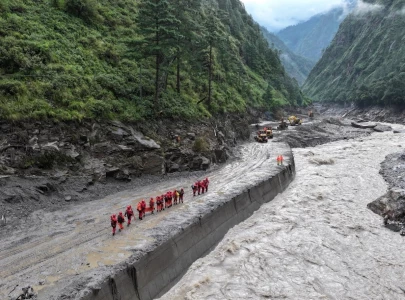 lake overflows on nepal china border sparking panic and halting rescue
