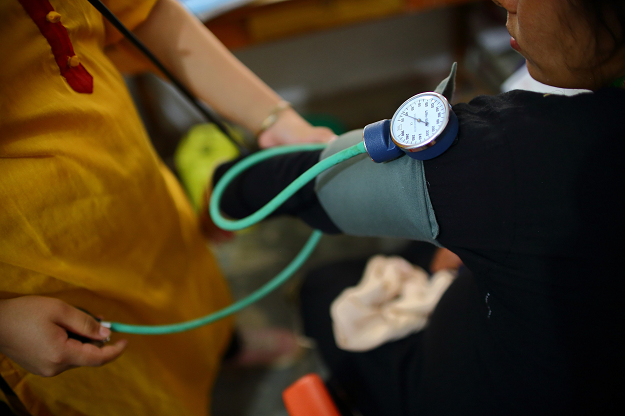 Nepali health worker giving free medicine to a pregnant woman at a health centre in the Ramechhap district. PHOTO: AFP.