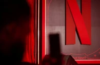 a man takes a photograph next to a netflix logo during an event in mumbai india february 3 2026 photo reuters