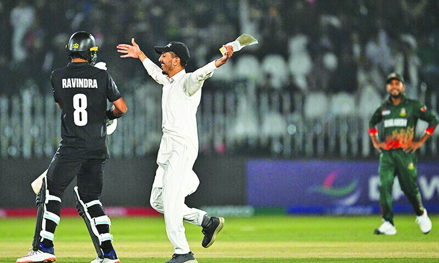 a fan runs towards rachin ravindra l during the icc champions trophy one day international odi cricket match between bangladesh and new zealand at the rawalpindi cricket stadium on february 24 photo afp