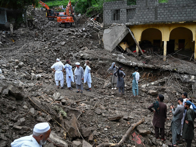 Residents watch as relief personnel search through the rubble of collapsed houses for victims during a rescue operation, a day after a cloudburst at the Dalori village in Swabi district, in Pakistan's mountainous Khyber-Pakhtunkhwa province on August 19, 2025. Photo: AFP