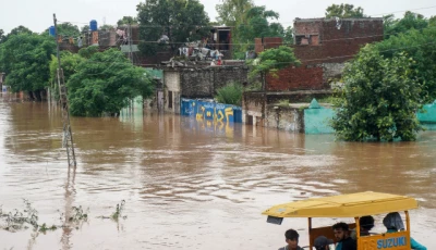 commuters ride in a rickshaw through a flooded area of wazirabad a town in punjab province on august 27 2025 photo afp