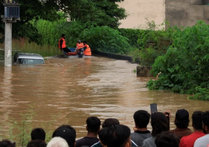 volunteers from rescue 1122 search for residents in a flooded area following monsoon rains and rising water levels in sialkot punjab province pakistan august 27 2025 photo reuters