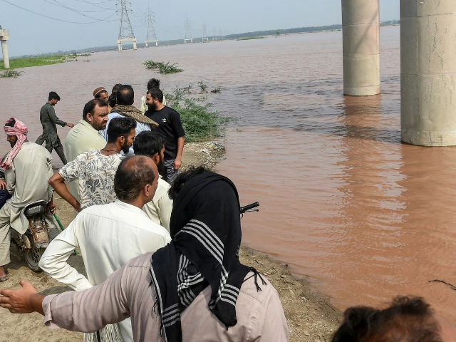 onlookers stand along the banks of the ravi river as the government announced a flood alert in the riverside areas of punjab province in lahore on august 27 2025 photo afp onlookers stand along the banks of the ravi river as the government announced a flood alert in the riverside areas of punjab province in lahore on august 27 2025 photo afp