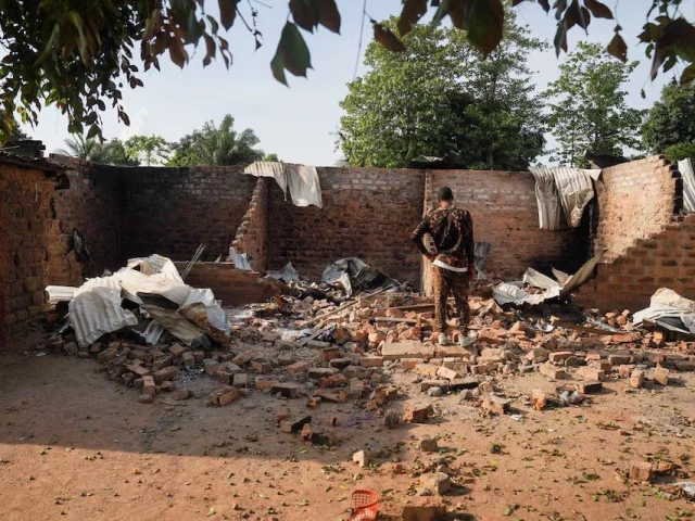 a man stands in front of a damaged and burnt house following a deadly gunmen attack in yelewata benue state nigeria june 16 2025 photo reuters