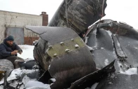 a man photographs parts of an unidentified missile which ukrainian authorities believe to be made in north korea and was used in a strike in kharkiv amid russia s attack on ukraine in kharkiv ukraine january 6 2024 photo reuters