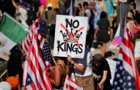 a protester holds a sign reading no kings with a crown illustration crossed out during a no kings protest against us president donald trump s policies in los angeles california on october 18 2025 photo reuters a protester holds a sign reading no kings with a crown illustration crossed out during a no kings protest against us president donald trump s policies in los angeles california on october 18 2025 photo reuters