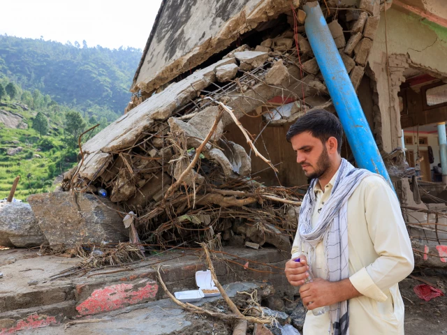noor muhammad 25 who lost 24 family members and relatives stands by the rubble of his 36 room house which was hit by devastating floods in the mountainous qadir nagar village of buner district khyber pakhtunkhwa province pakistan august 21 2025 photo reuters