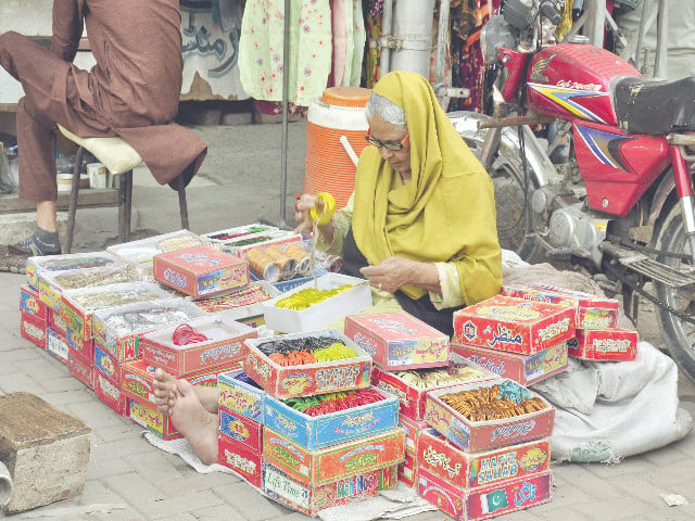 an elderly woman sells bangles along satyana road in faisalabad international women s day was observed across the world on saturday photo online