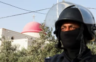 a member of security personnel stands outside saint george s greek orthodox church where gunmen opened fire during a funeral the previous day in the village of hamoud karak jordan october 24 2026 reuters